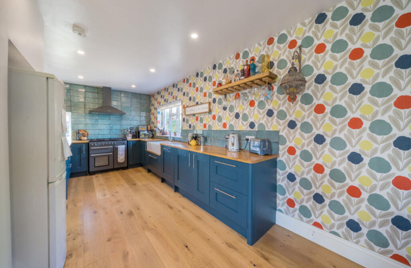 Blue shaker kitchen in a Raptor Construction renovation in Tewkesbury
